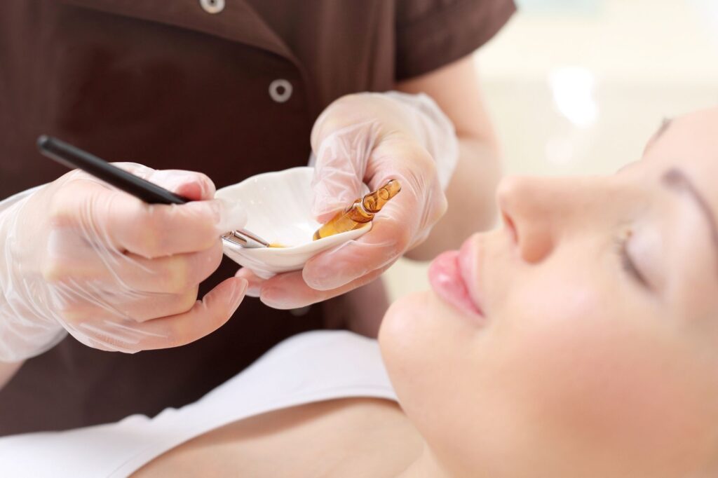 Chemical peel in progress - a beautician at Skin Redefined is preparing the solution to apply to the client's face